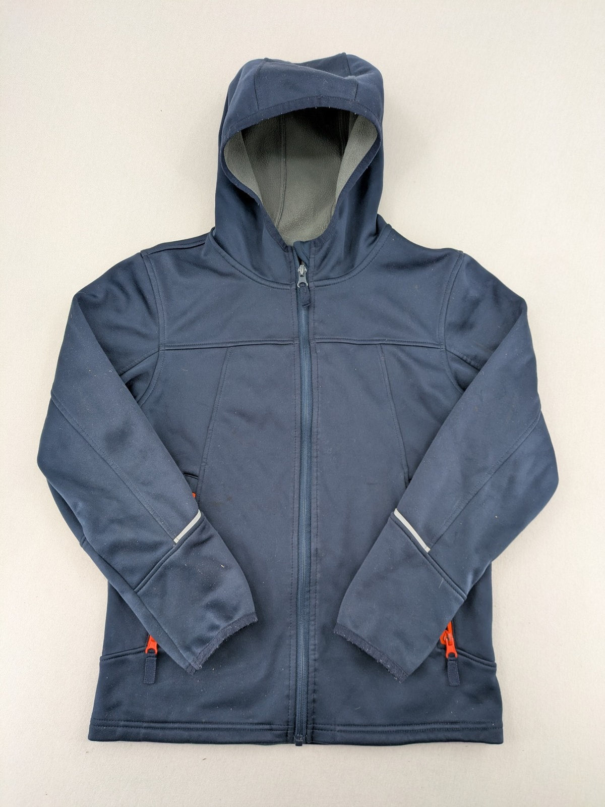 Crane navy softshell jacket with fleece lining, full zip, orange accent zippers.