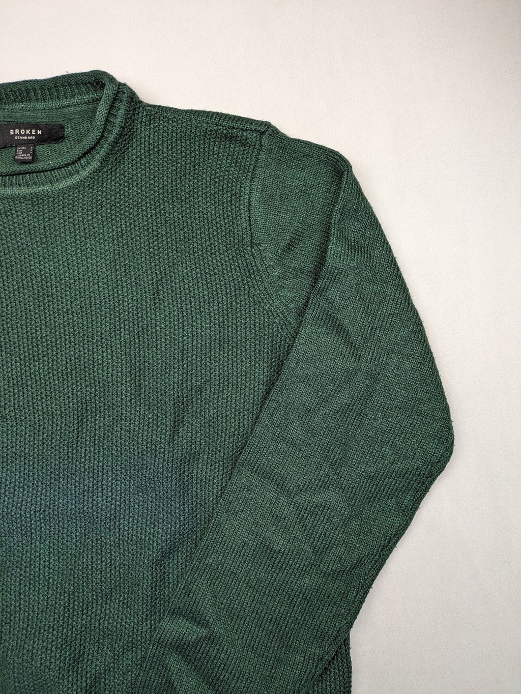 Broken Standard turtle neck jumper green waffle knit texture with classic round neckline.
