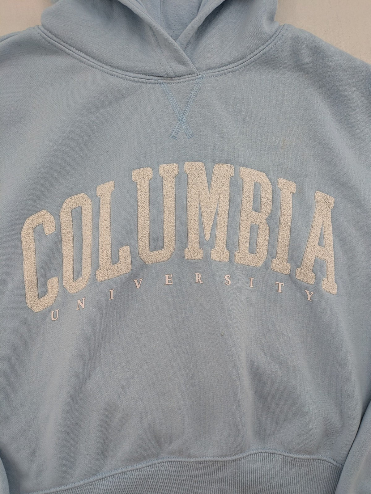 Columbia University blue hoodie with large "Columbia University" text on chest.