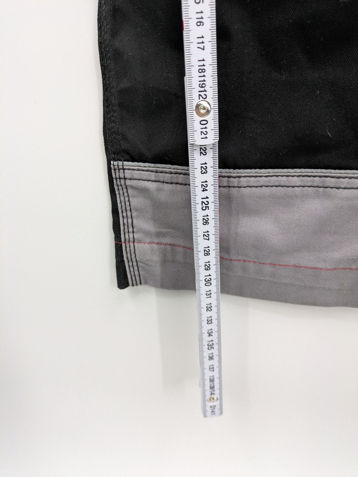 Cargo pants black grey two-tone design with red stitching and multiple pockets
