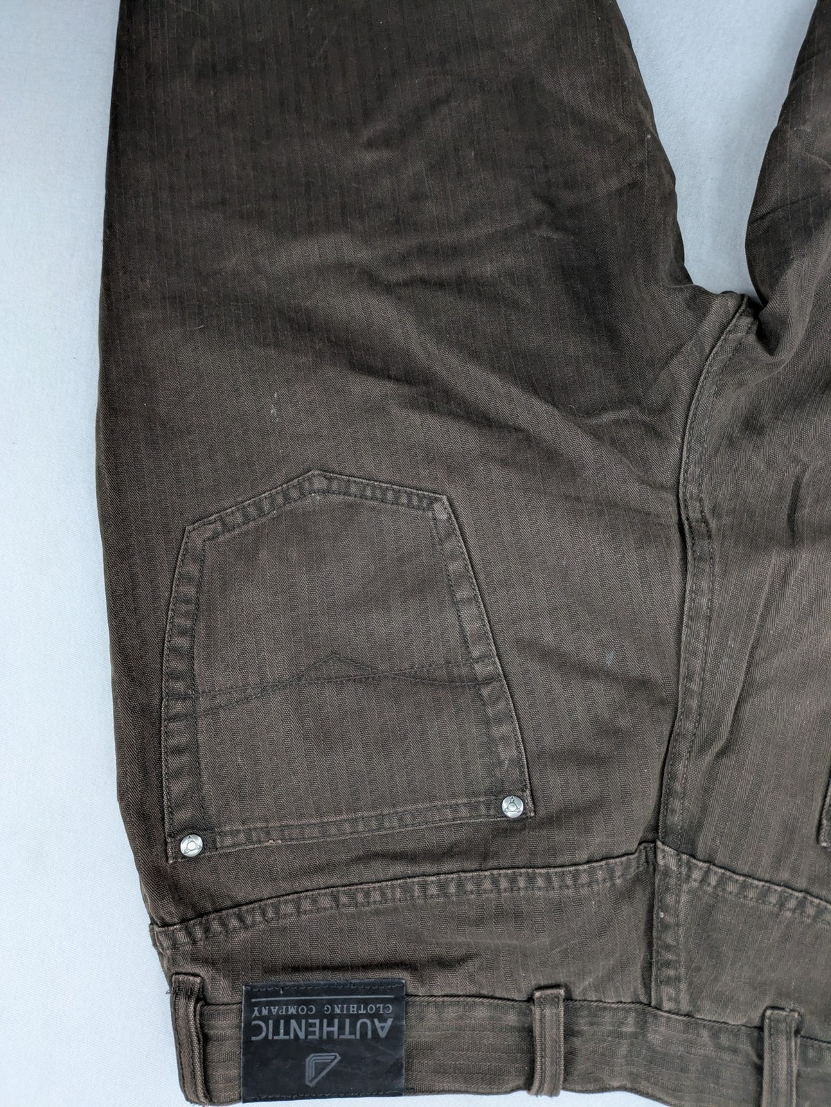 Authentic Clothing Company brown straight jeans with subtle stripe pattern and brand patch.