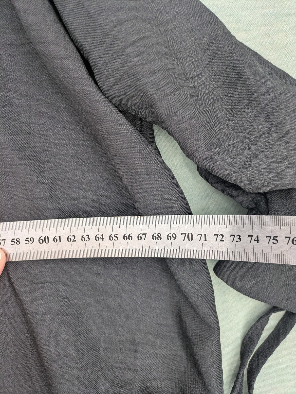 Damen grey turtle neck jumper with balloon sleeves and side ties, high-low hem.