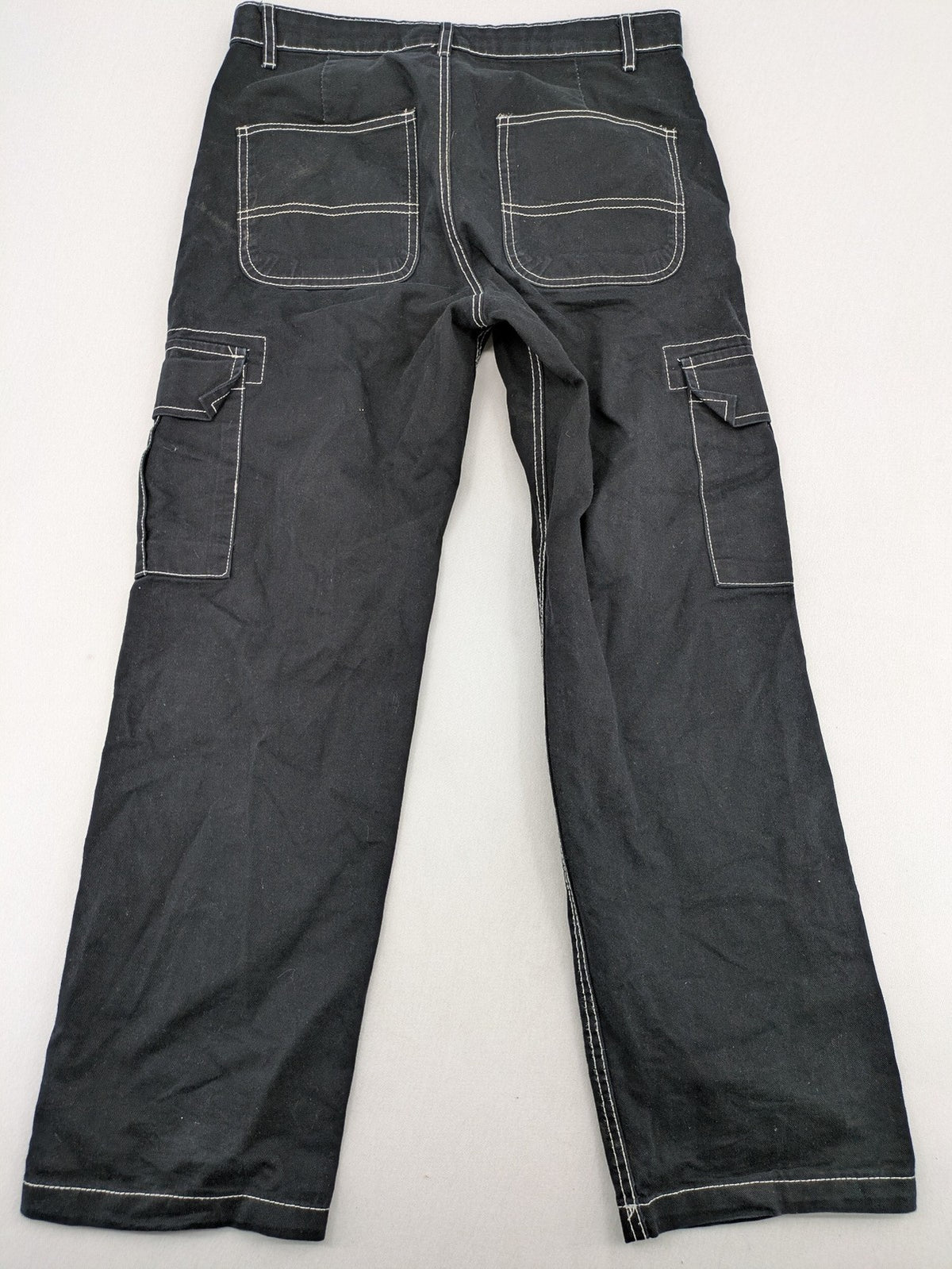 FSBN black baggy cargo pants with white contrast stitching and multiple pockets.