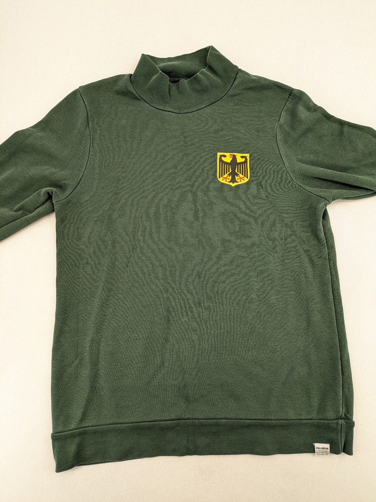 Pull & Bear green sweatshirt with embroidered Germany eagle patch and mock neck.
