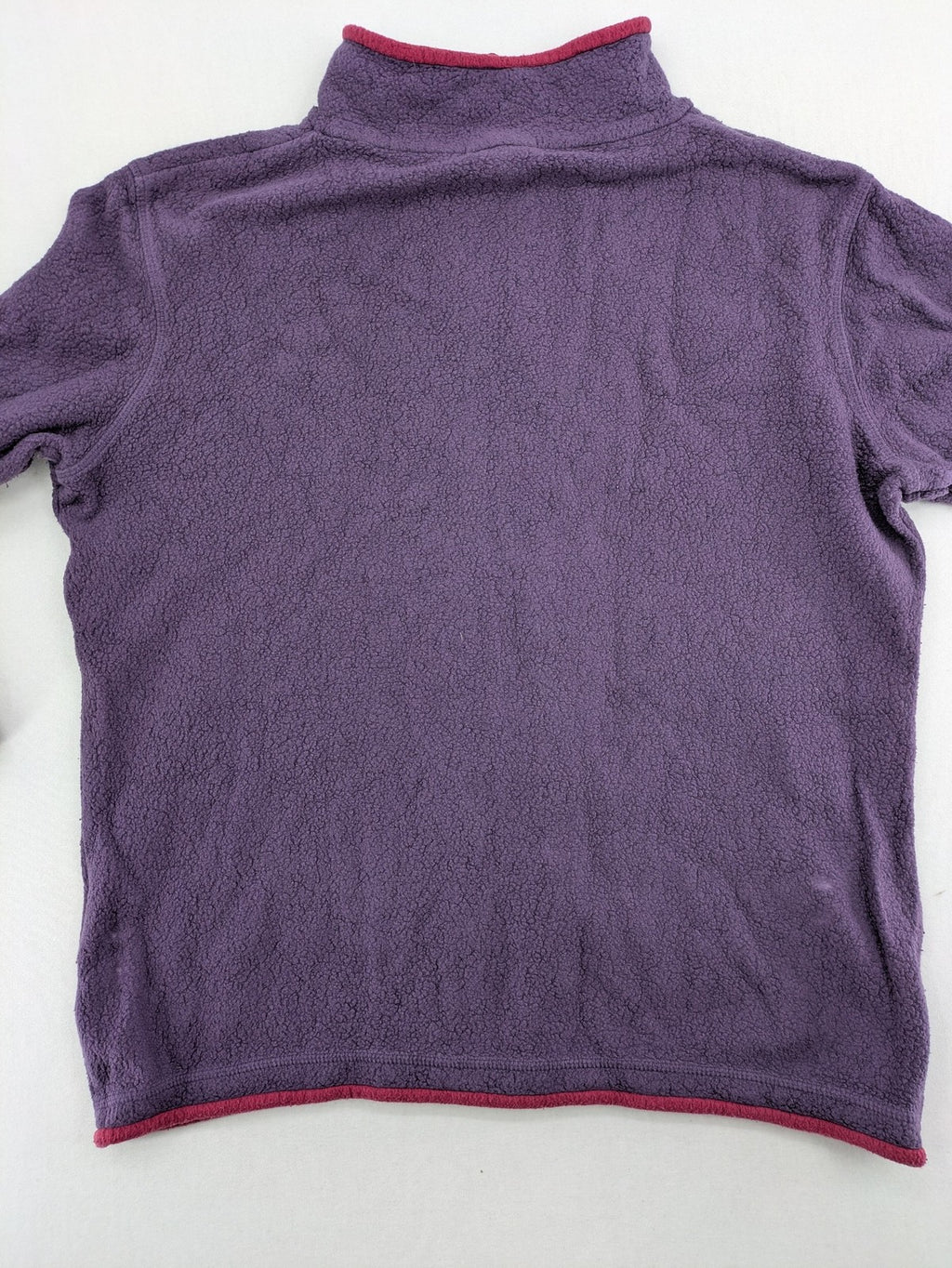Waschbär pink and purple fleece jacket with red contrast details and high collar.