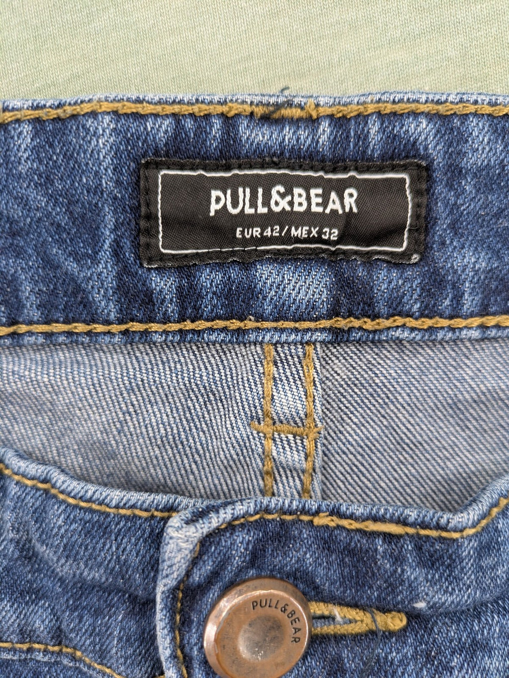 Pull & Bear blue distressed ripped straight jeans with button fly and classic wash.