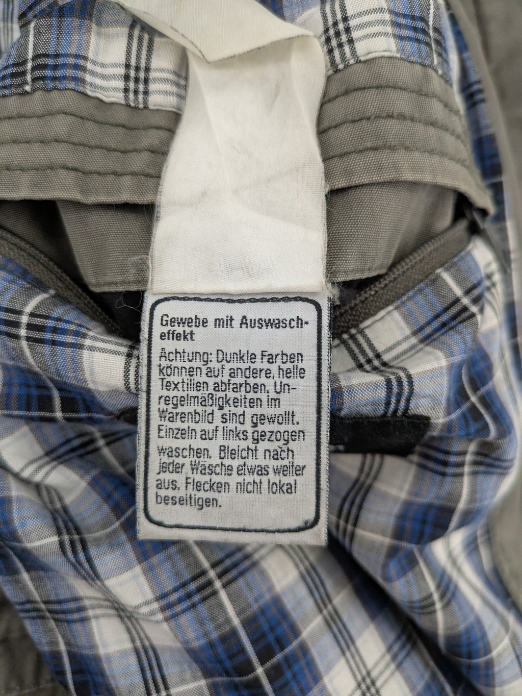 Walbusch khaki military jacket with checkered blue-white lining and multiple pockets.