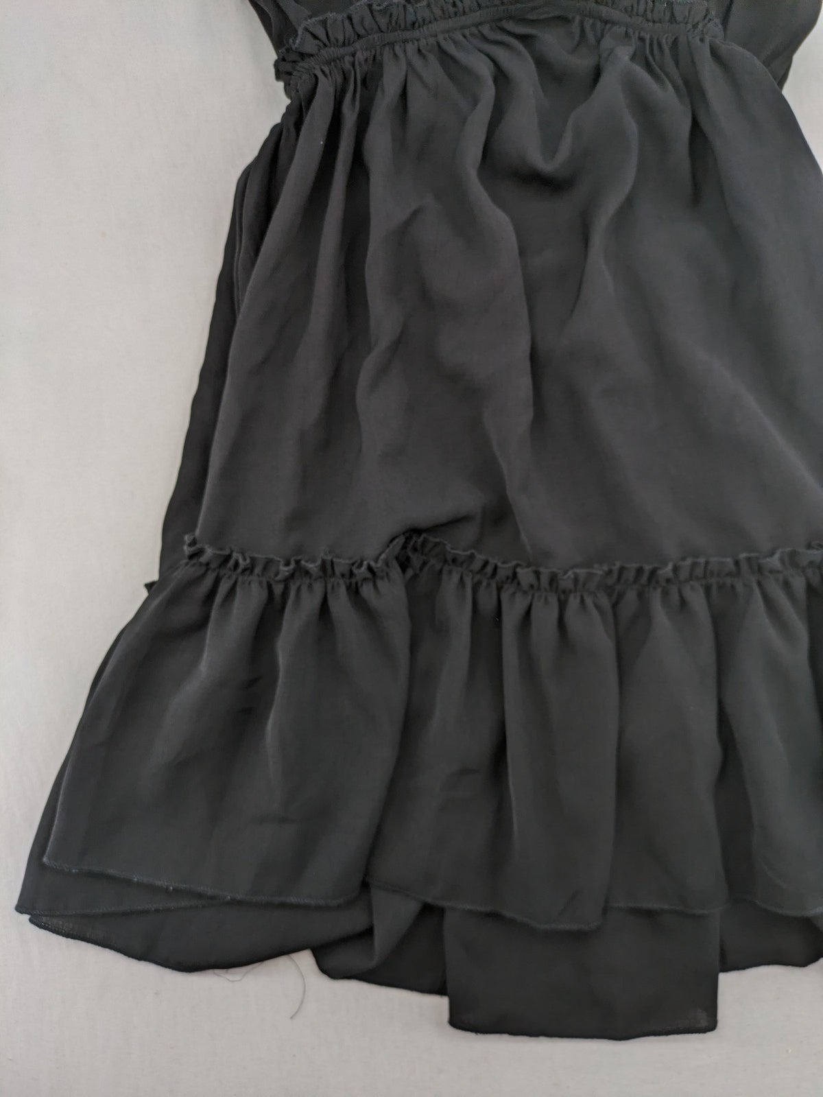 SHEIN grey mini dress with open back, adjustable tie, and ruffled hem.