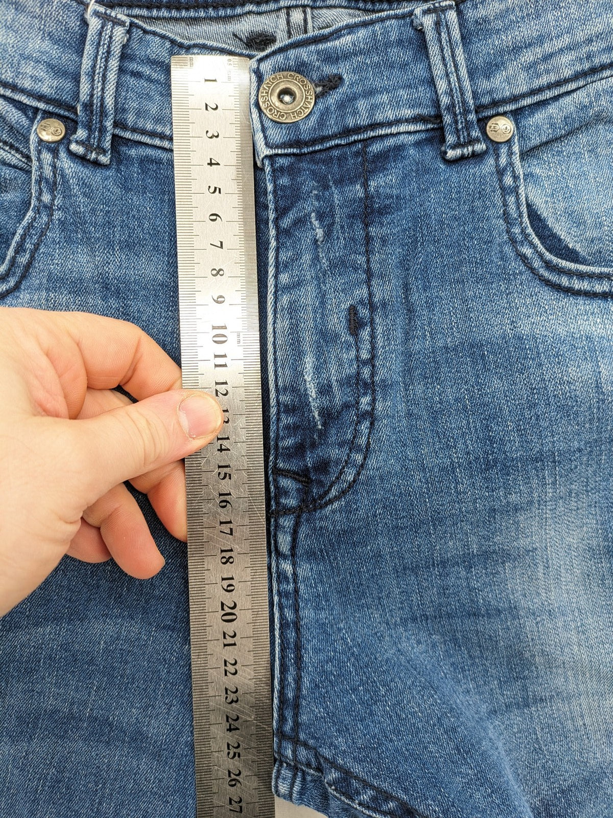 Crosshatch blue slim fit jeans with faded wash and logo patch on back pocket.