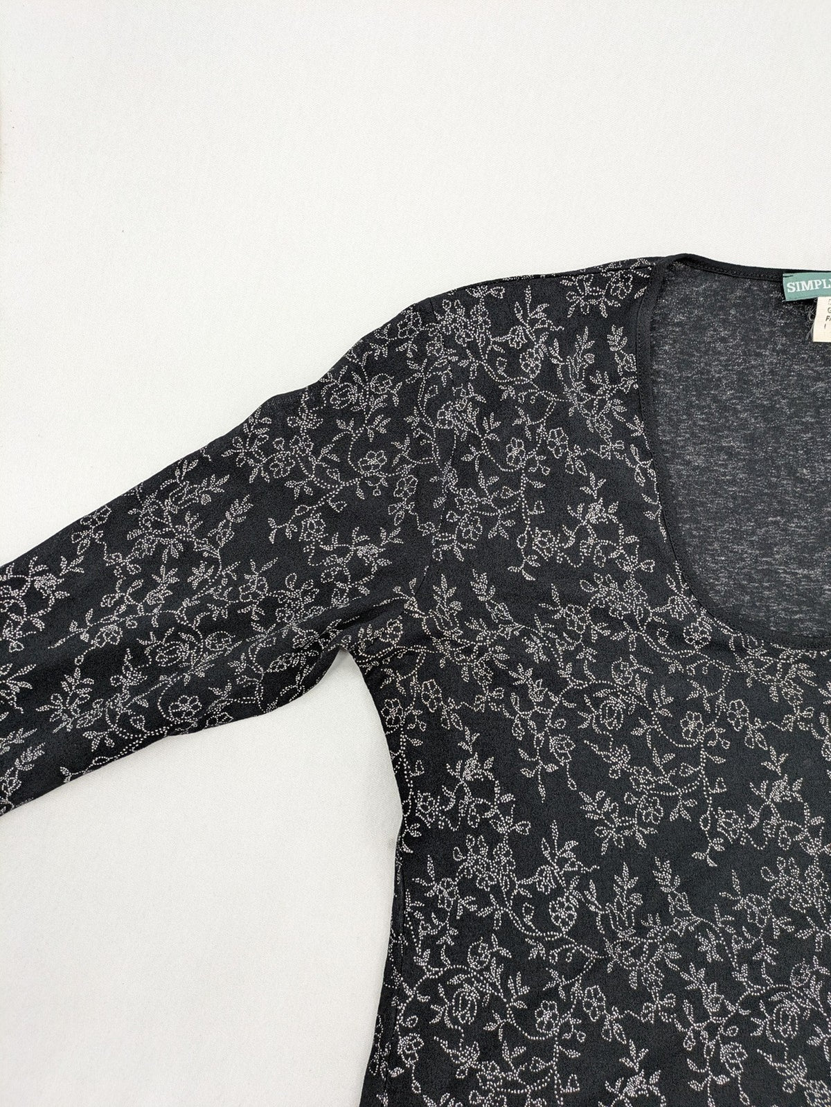 Simply The Best black top with white floral pattern and gathered front detail.