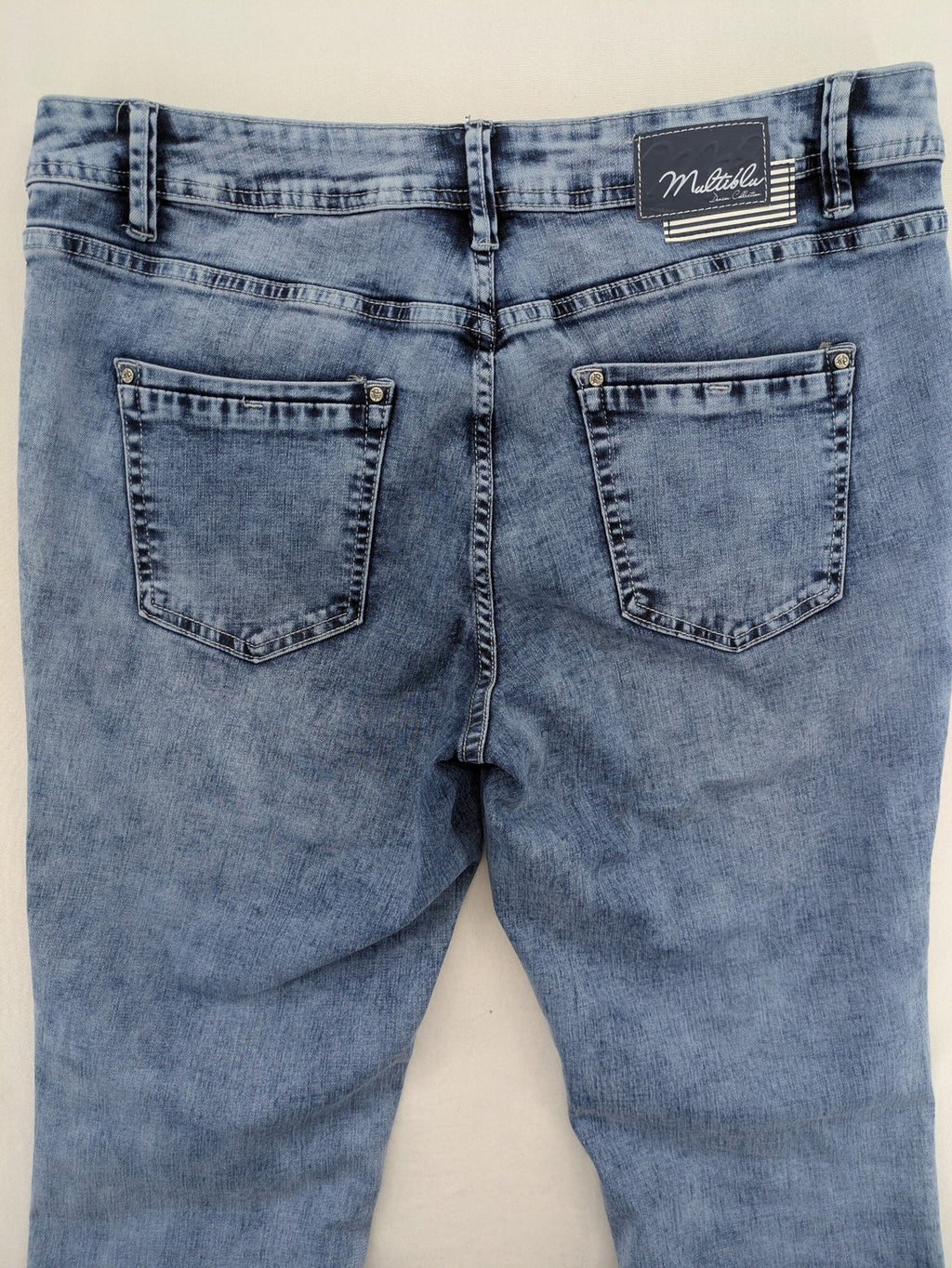 Multiblu blue straight jeans slim fit with decorative front zippers and light wash.