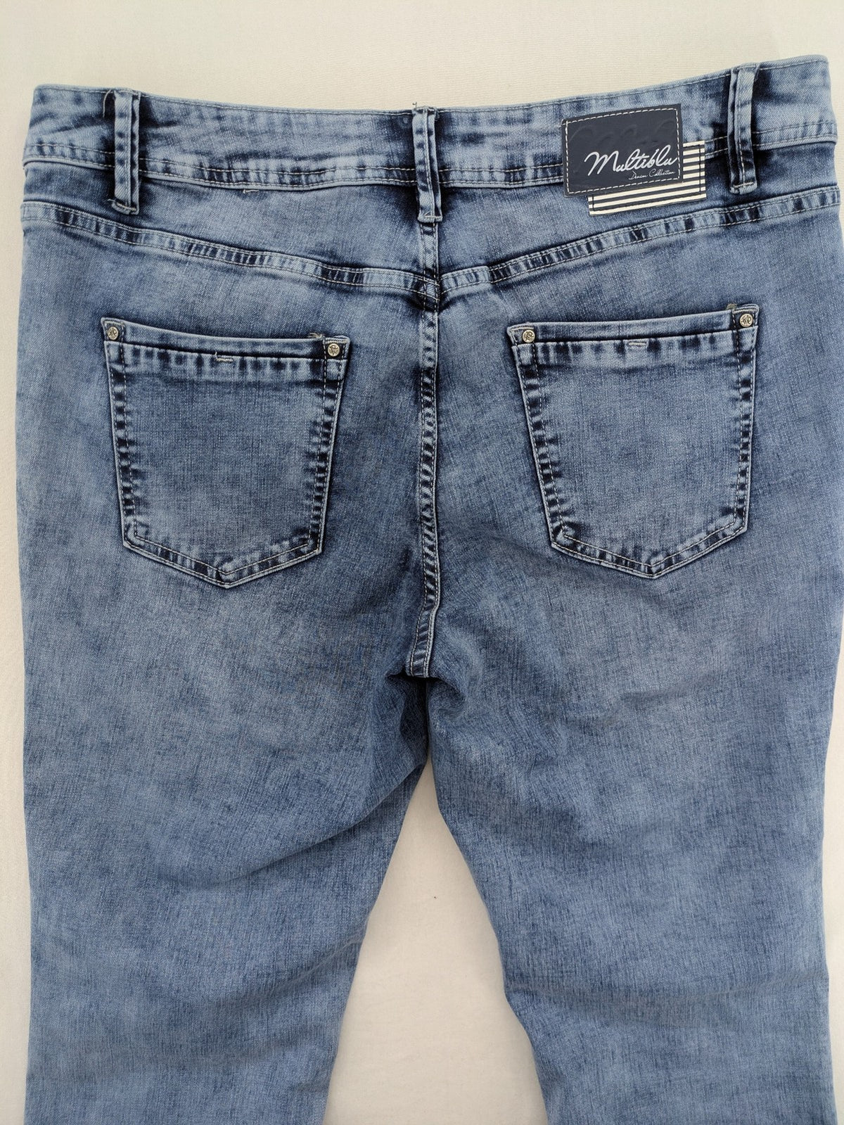 Multiblu blue straight jeans slim fit with decorative front zippers and light wash.