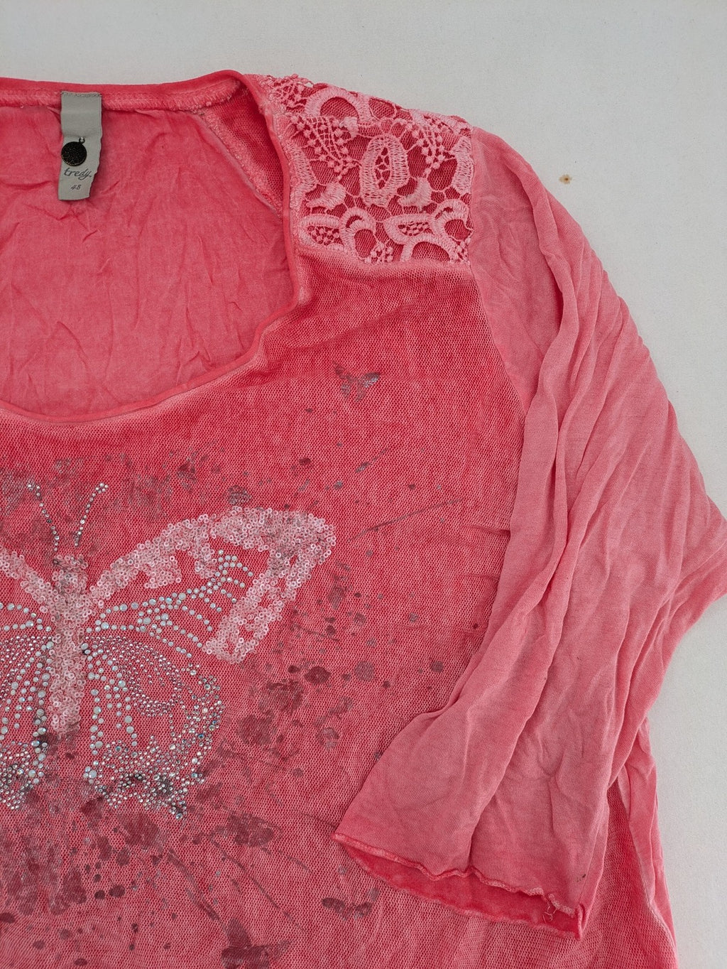TREDY pink top with butterfly graphic, embellished with rhinestones and lace accents.