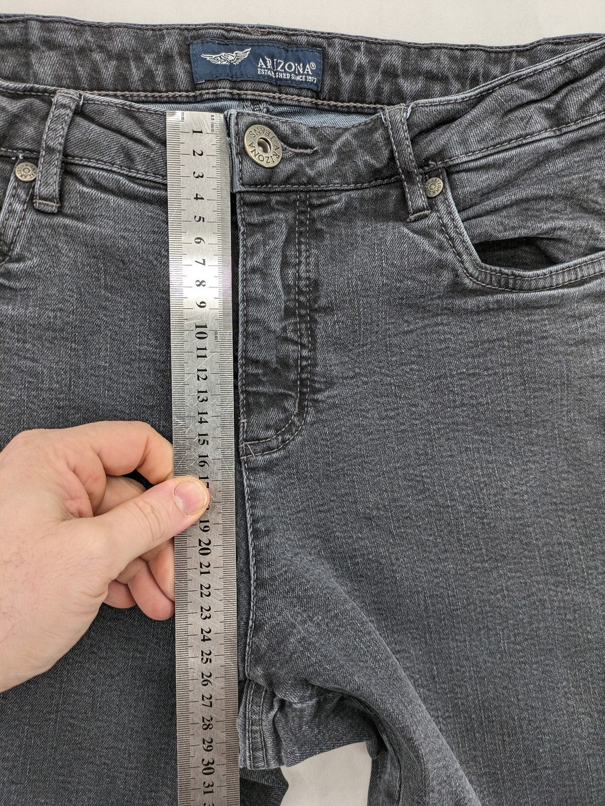 Arizona grey straight jeans with pearl-embellished wing appliqué on back pocket.