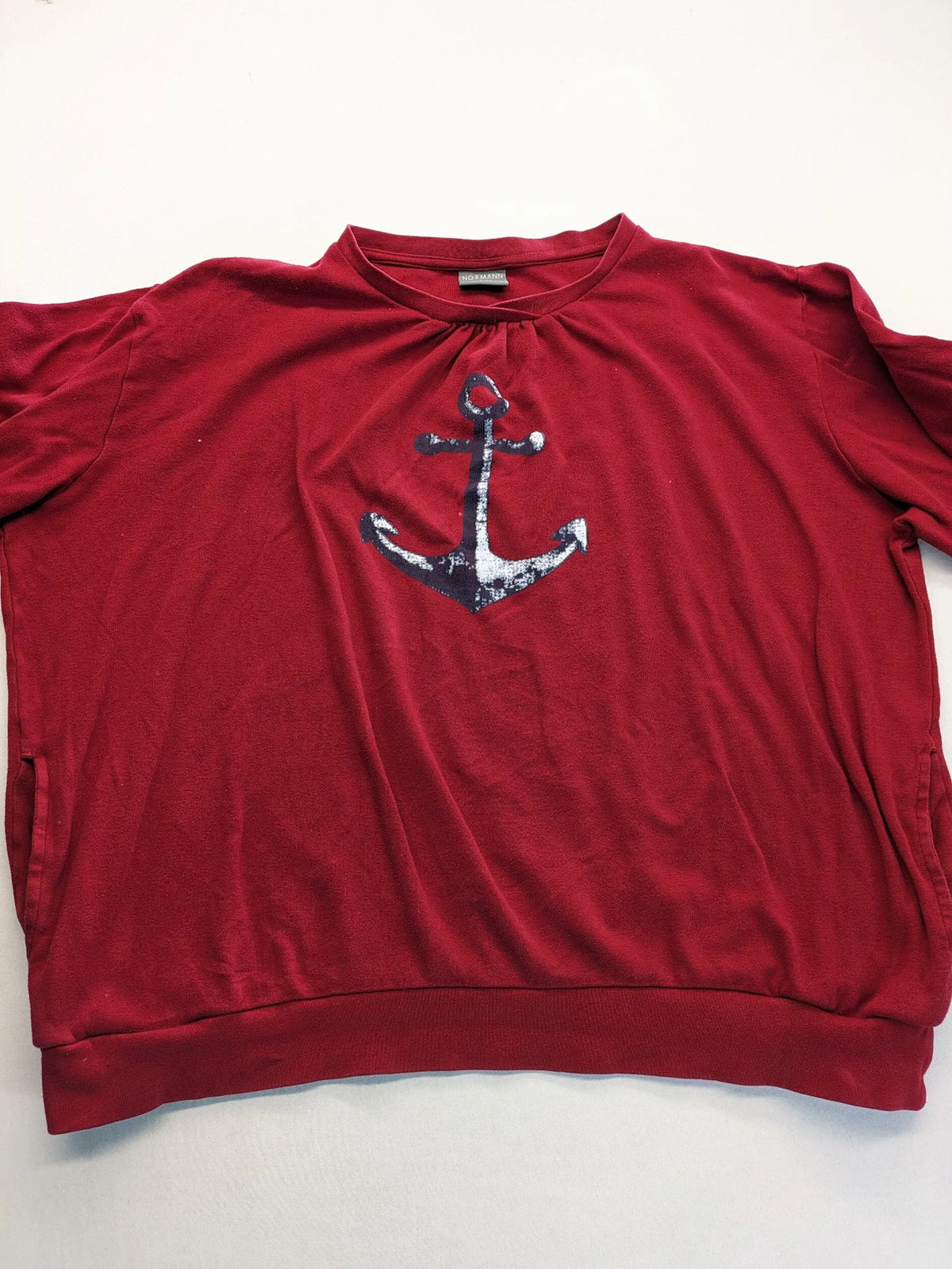 Normann red turtle neck jumper with large anchor print and side pockets.