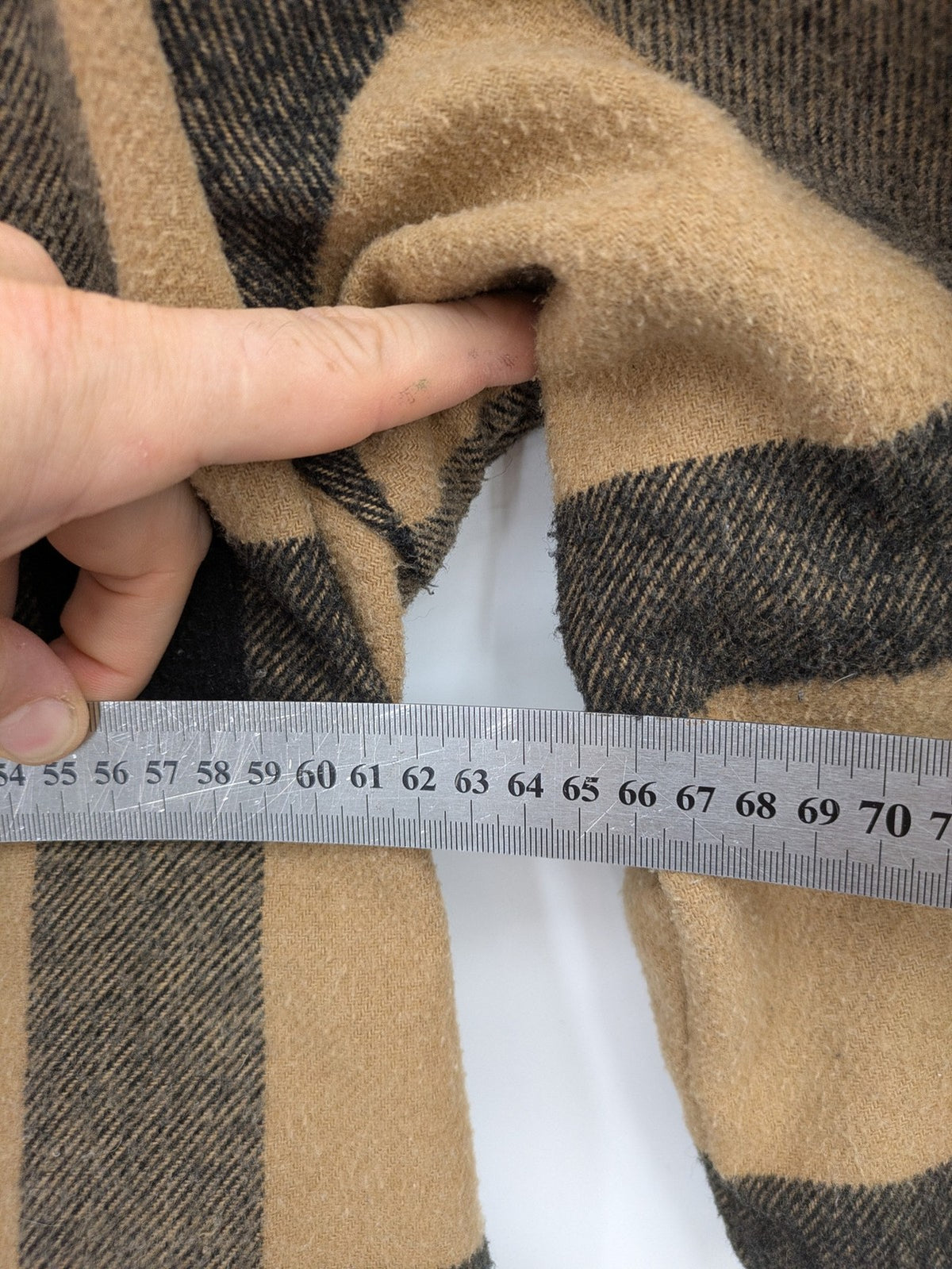 Reserved cream coat with brown and black check pattern, fringe hem, wool blend material.