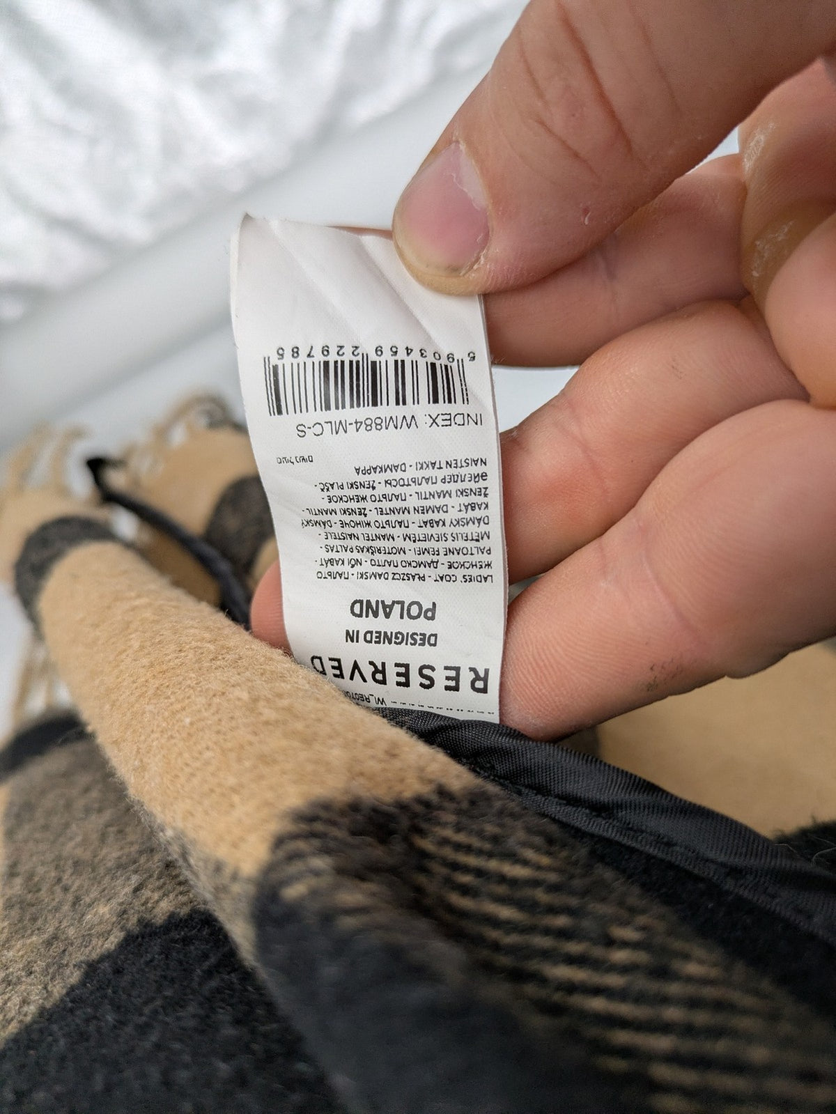 Reserved cream coat with brown and black check pattern, fringe hem, wool blend material.