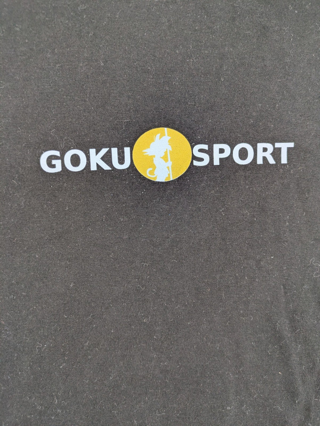 Dragon Ball Z black t-shirt featuring Goku Sport logo and silhouette on Flying Nimbus.