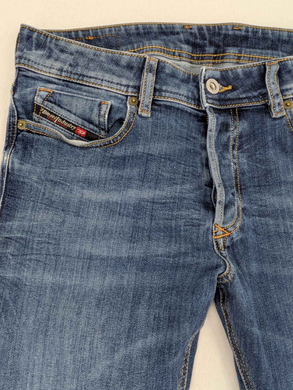 Diesel blue slim skinny jeans with logo patch and stretch denim material.