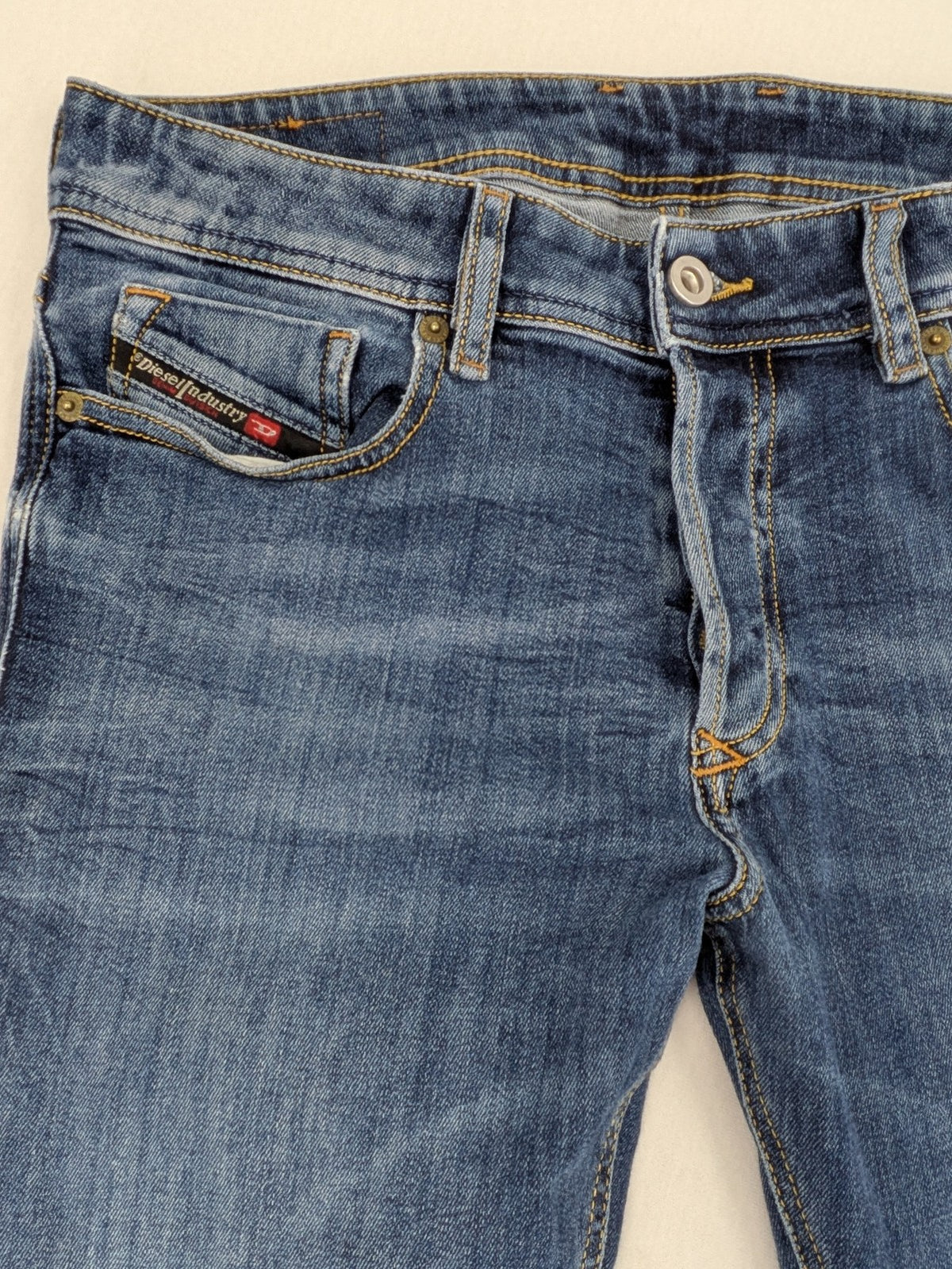 Diesel blue slim skinny jeans with logo patch and stretch denim material.