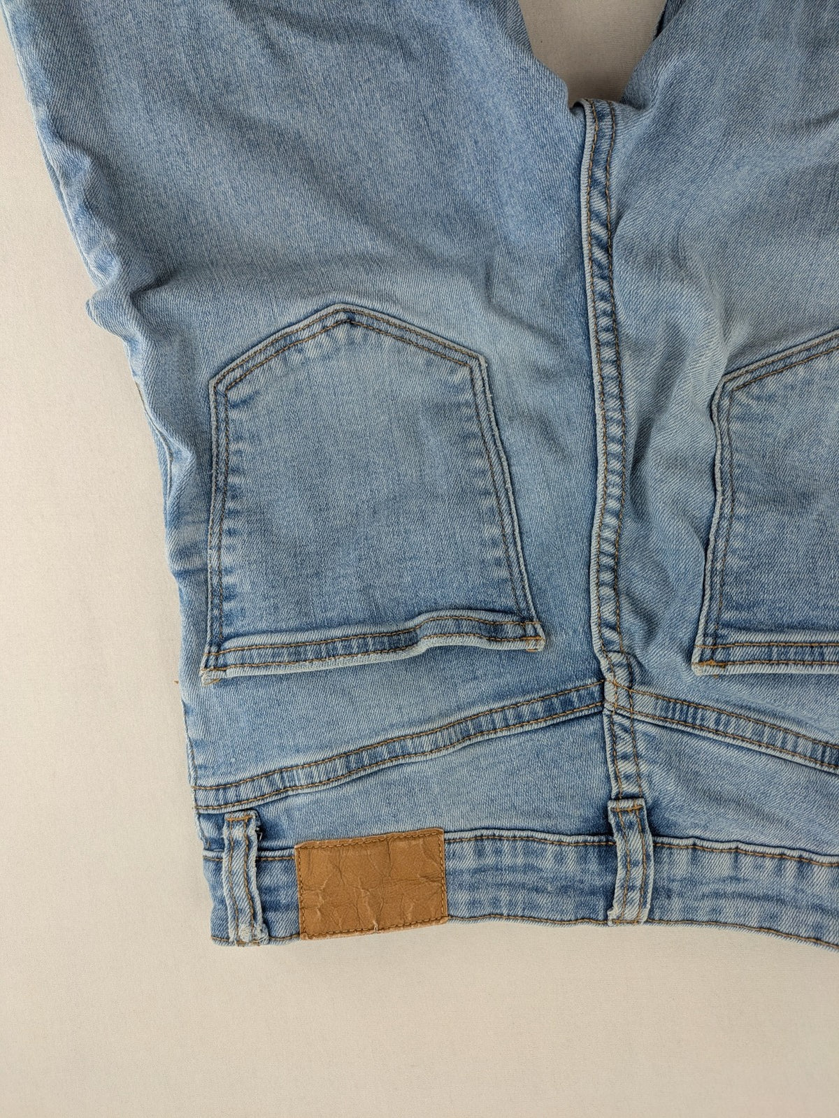 Bershka blue super high waist skinny jeans with washed denim finish and zip closure.