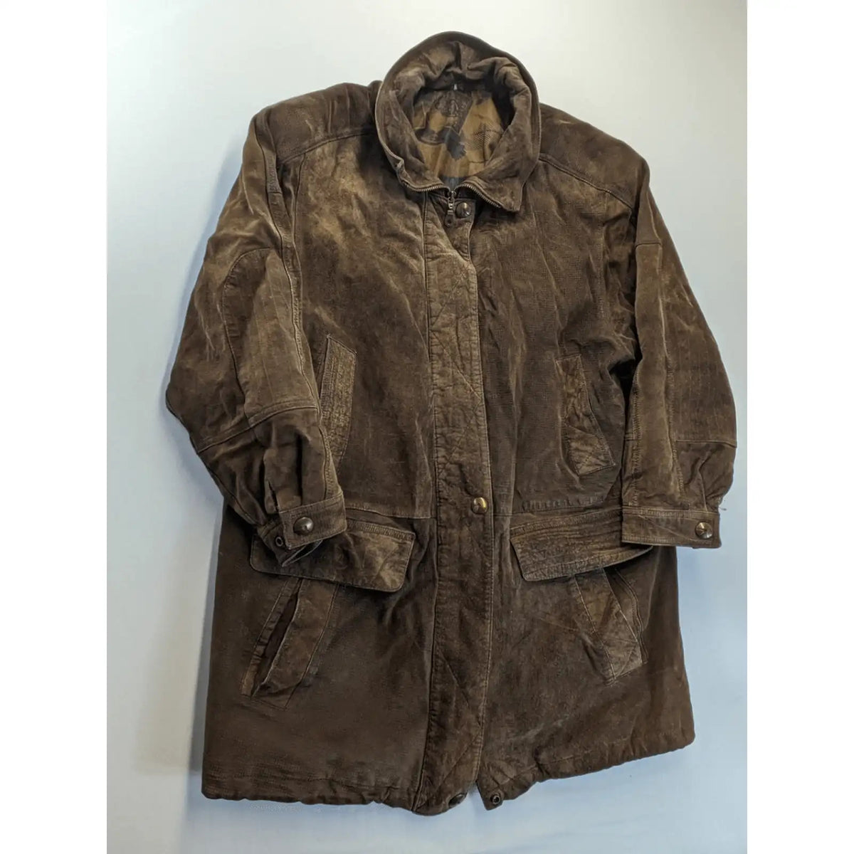 Vintage brown leather jacket with graphic lining, zip closure, and button placket.