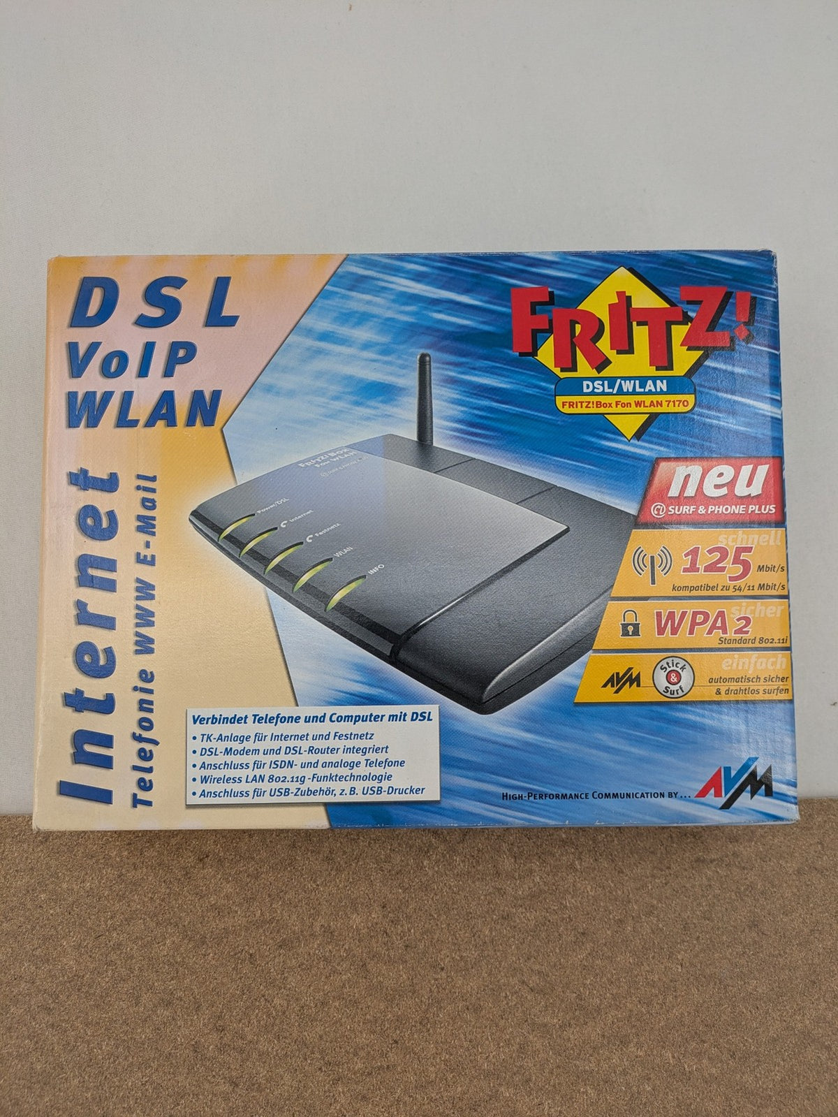 AVM wireless router black grey yellow with logo and integrated DSL modem features.