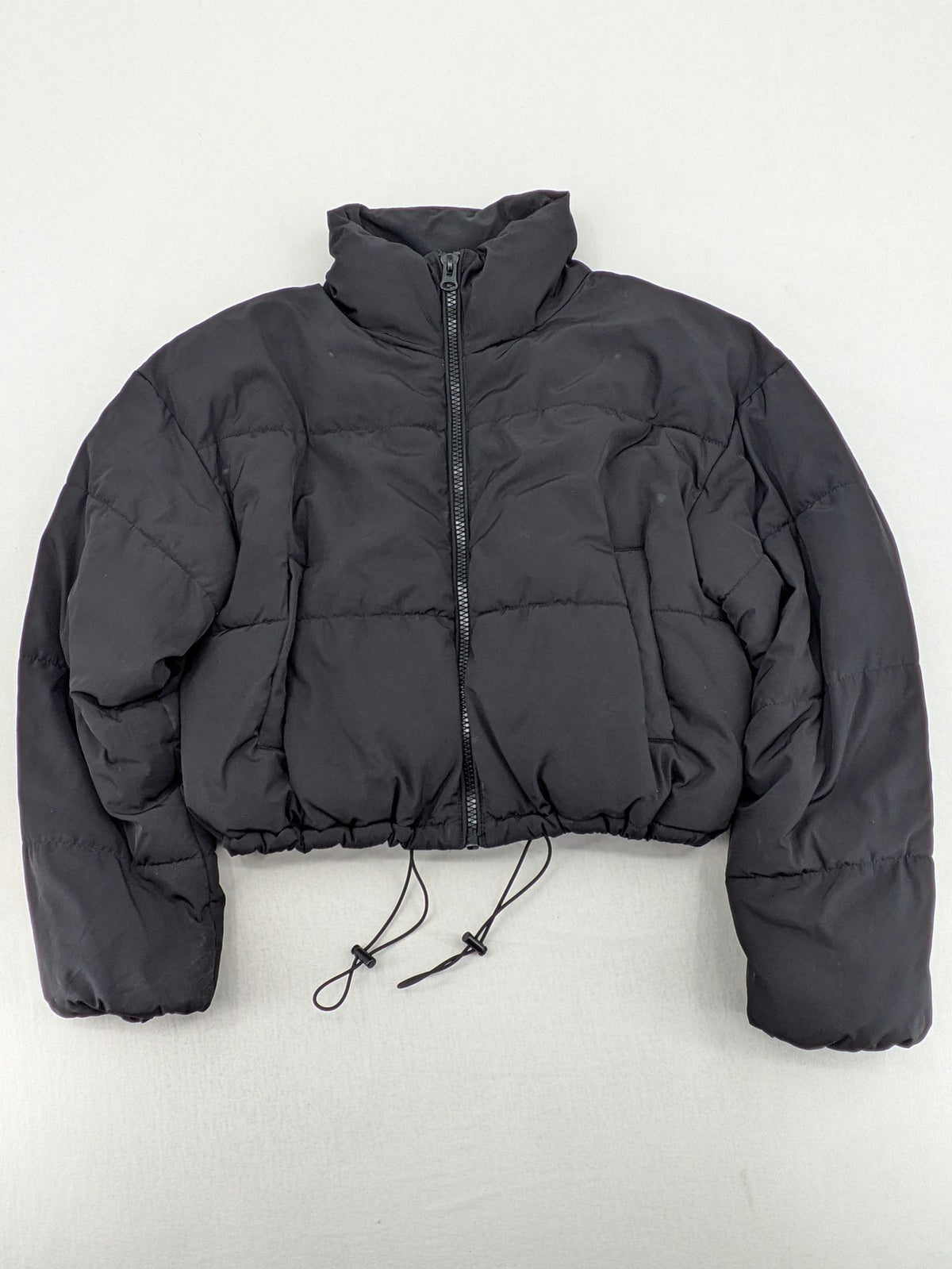 H&M Divided black cropped puffer jacket with zip closure and high collar.