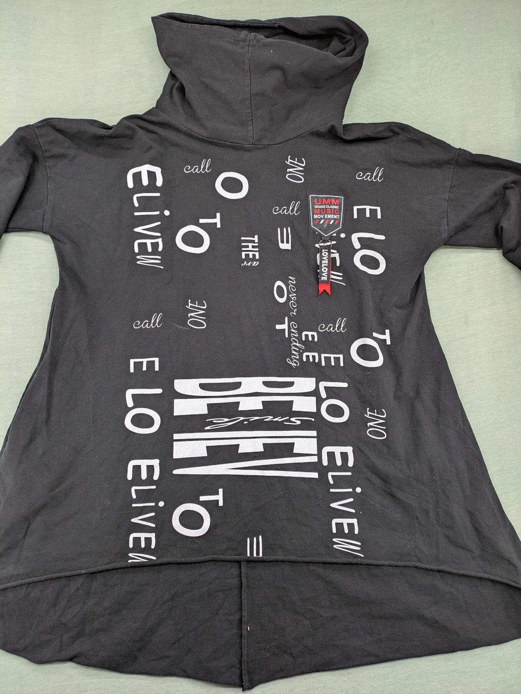 MEGI Collection black hoodie dress with graphic print and asymmetrical high-low hem.