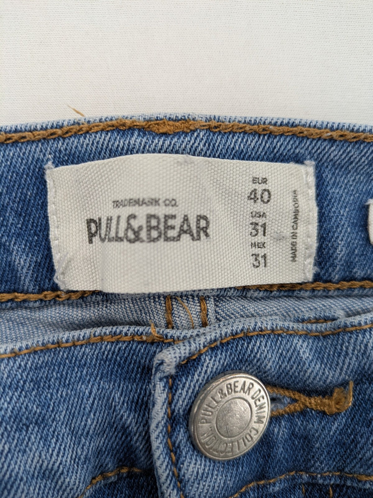 Pull&Bear blue carrot fit jeans with distressed knees and frayed hems.