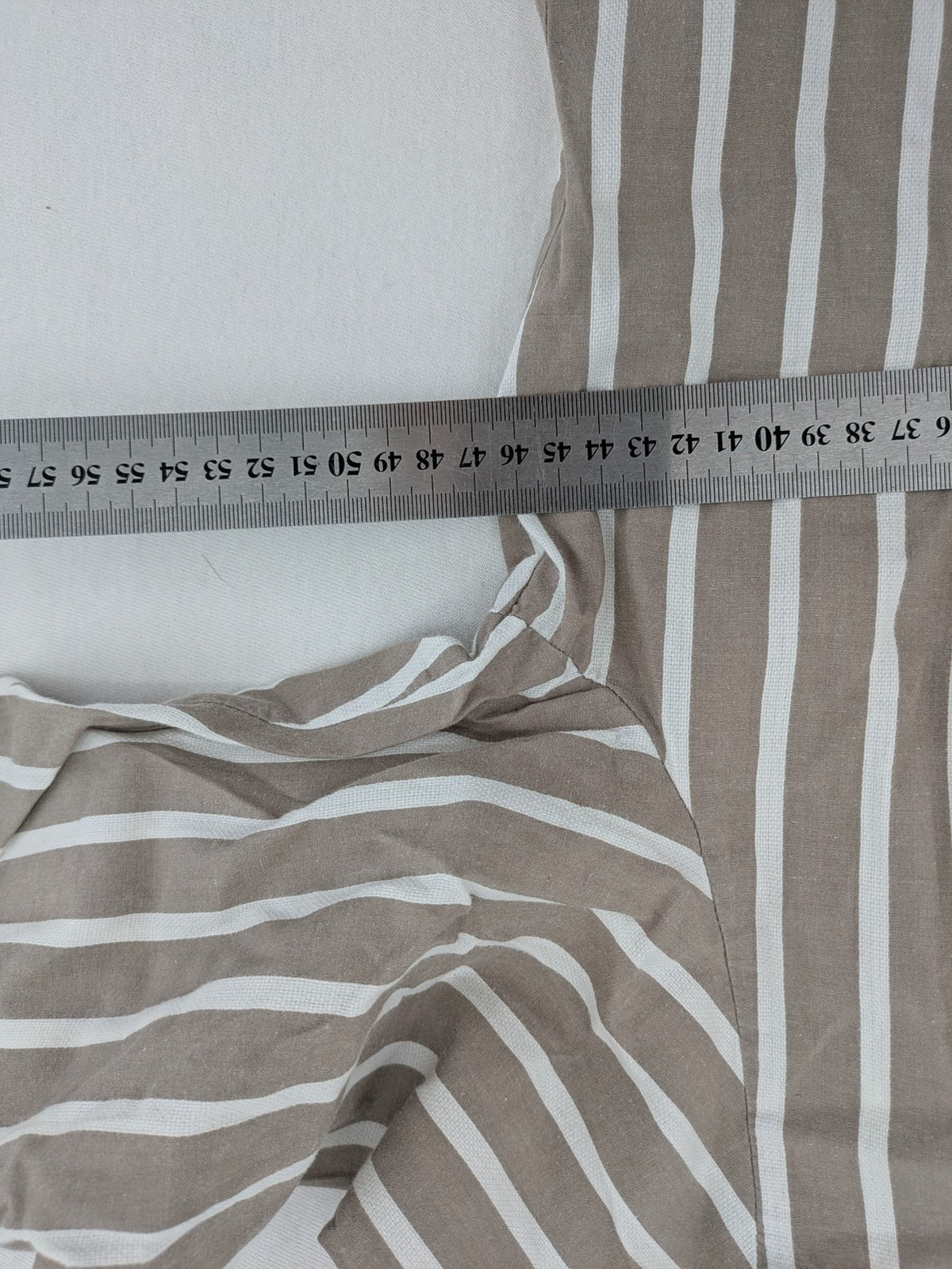 Body Sunday beige and white striped loungewear top with bow accents and button placket.