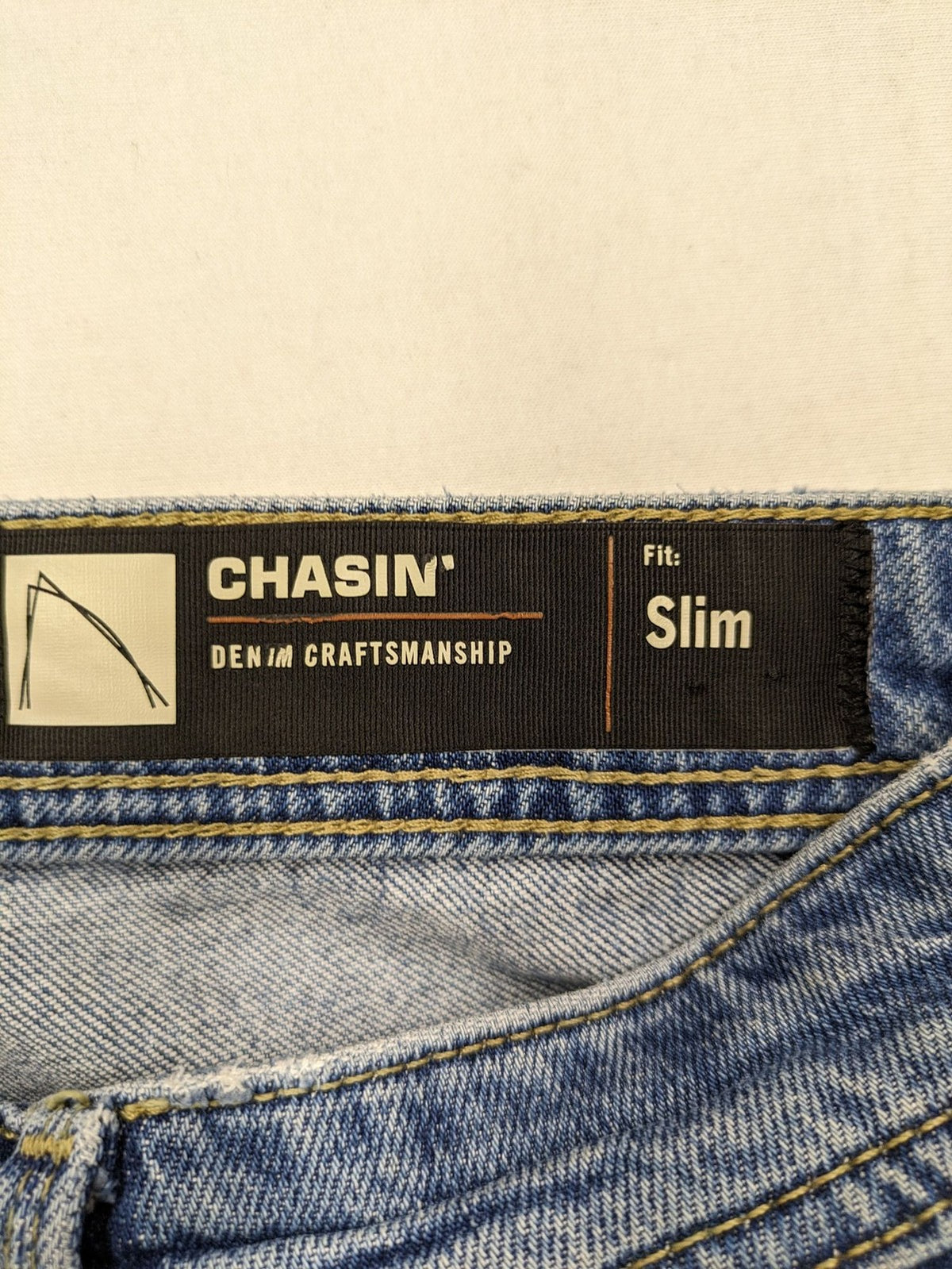 CHASIN' blue slim fit jeans with button fly and classic denim craftsmanship.