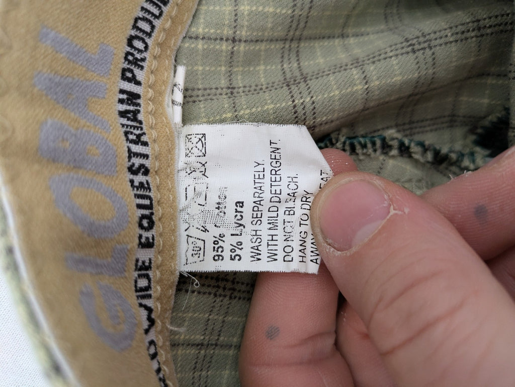 Jodhpur beige and grey riding pants with green check pattern and knee patches.