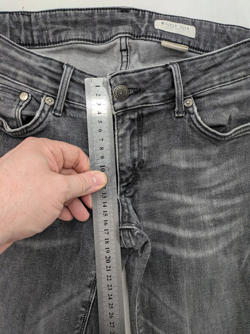 H&M grey skinny jeans with low rise, classic 5-pocket style, and washed denim finish.
