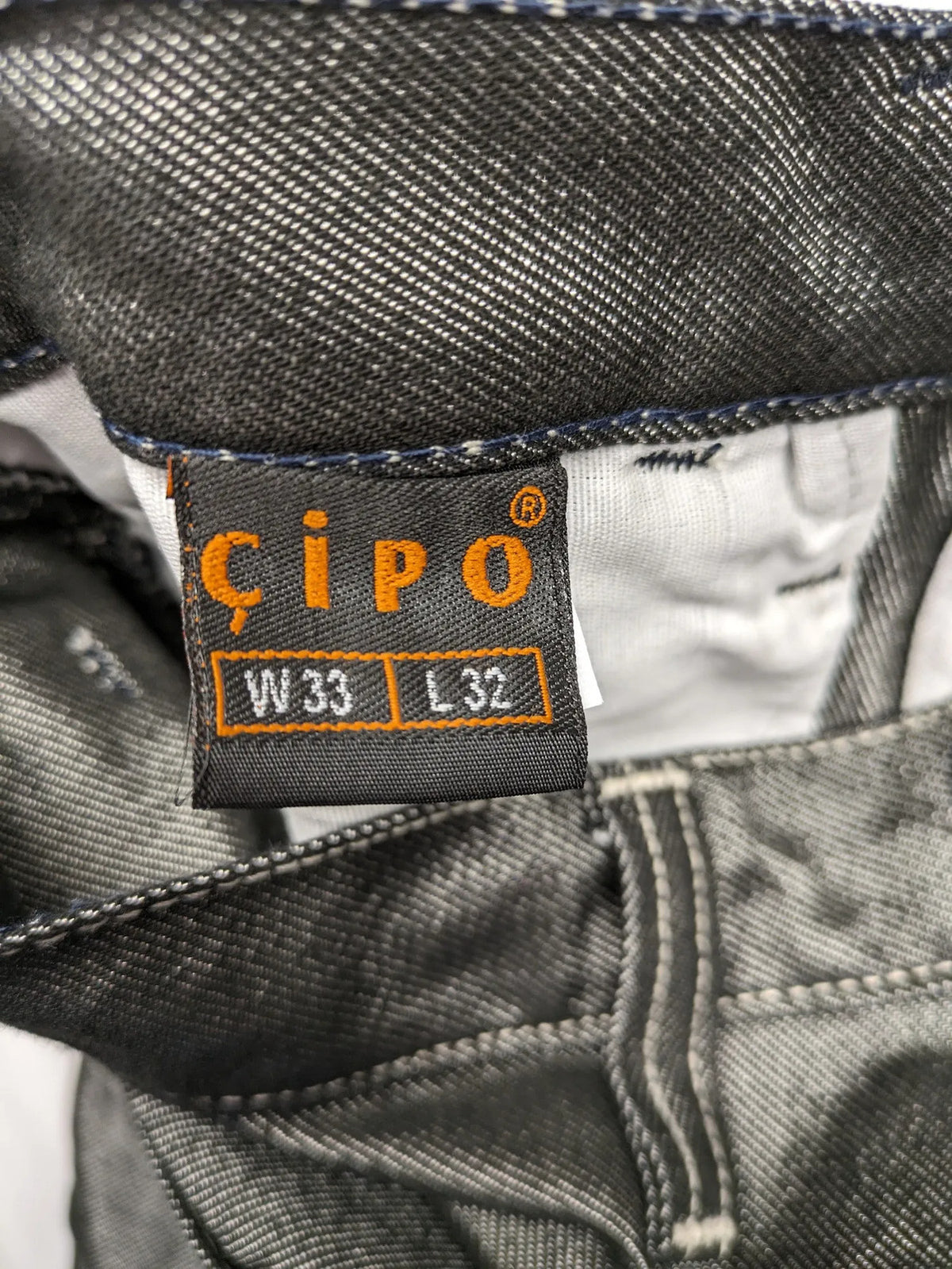 CIPO grey bootcut biker jeans with white contrast stitching and moto-inspired knee pleats.
