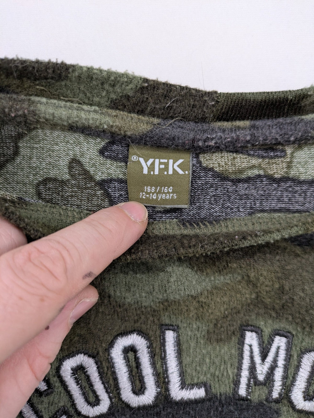 YFK turtle neck jumper multi camouflage print with sequined "COOL MOOD Today" graphic.