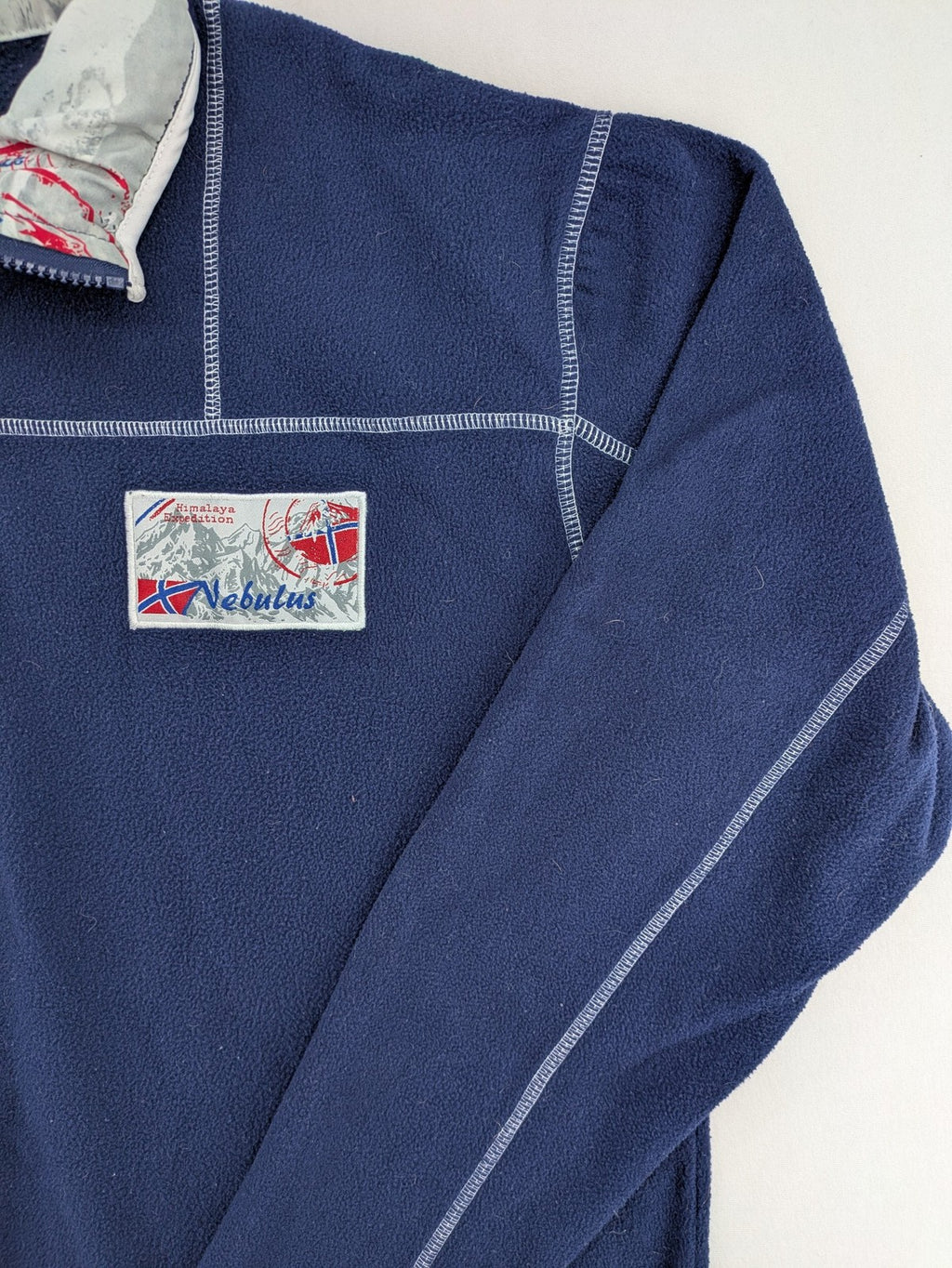 Nebulus navy turtle neck jumper with graphic print collar and "Himalaya Expedition" patch.