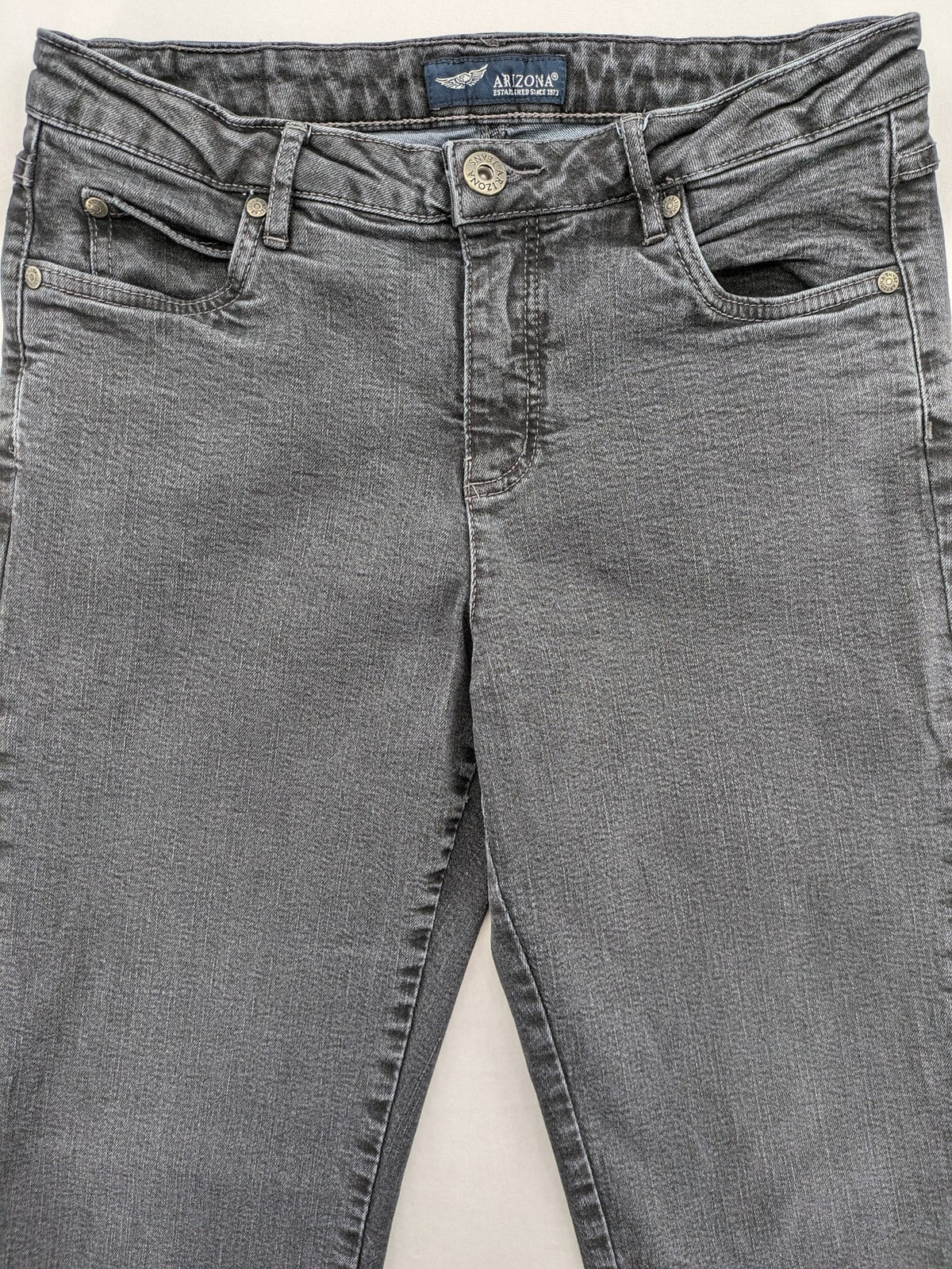 Arizona grey straight jeans with pearl-embellished wing appliqué on back pocket.