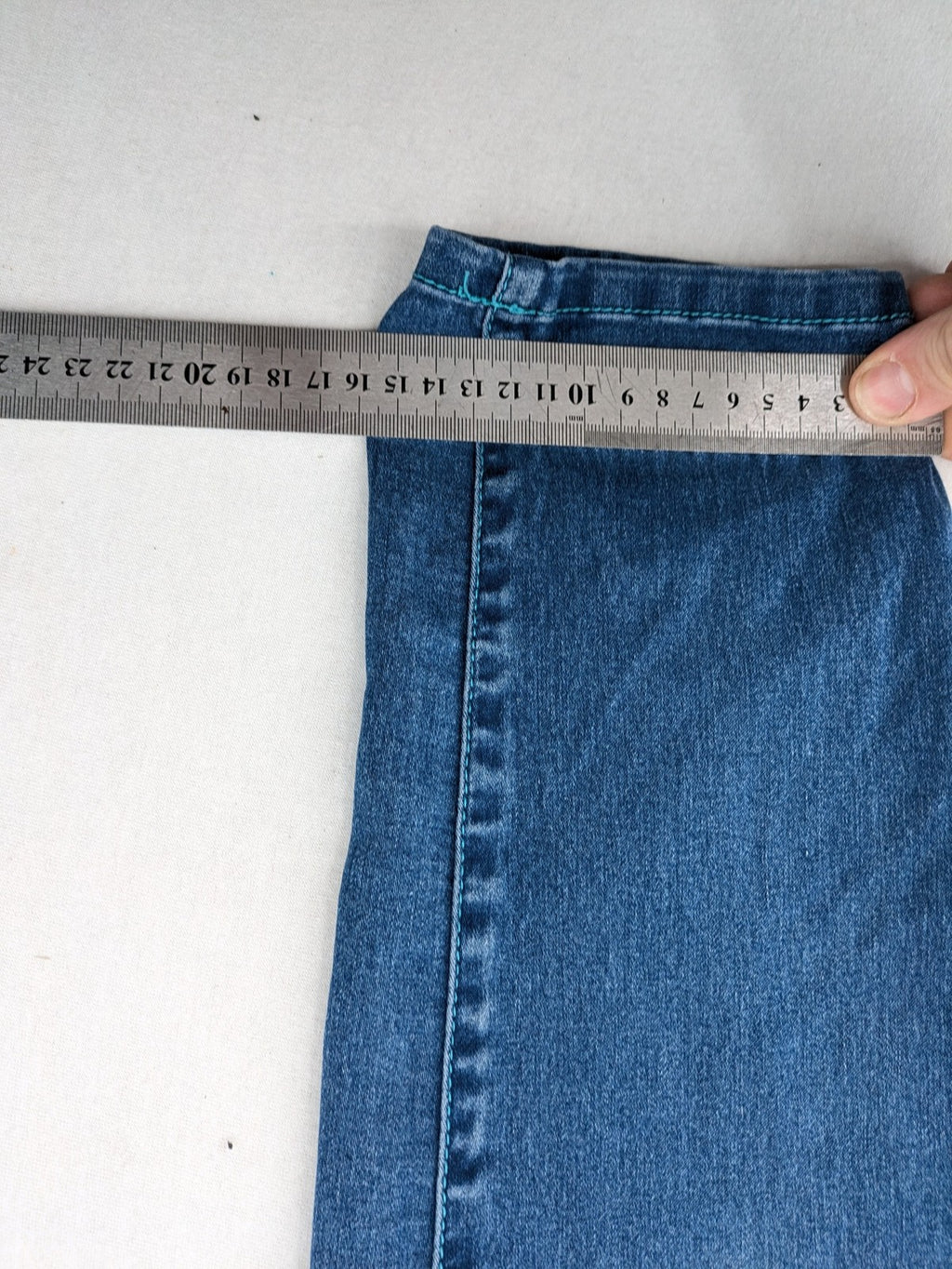 Rainbow blue straight jeans jogger style with button fly and contrasting turquoise stitching.