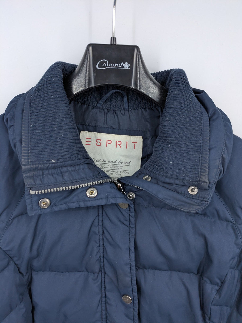 Esprit navy puffer jacket with belt, high collar, ribbed inner lining, and button placket.