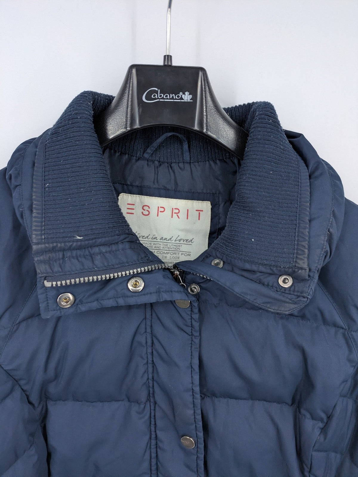 Esprit navy puffer jacket with belt, high collar, ribbed inner lining, and button placket.