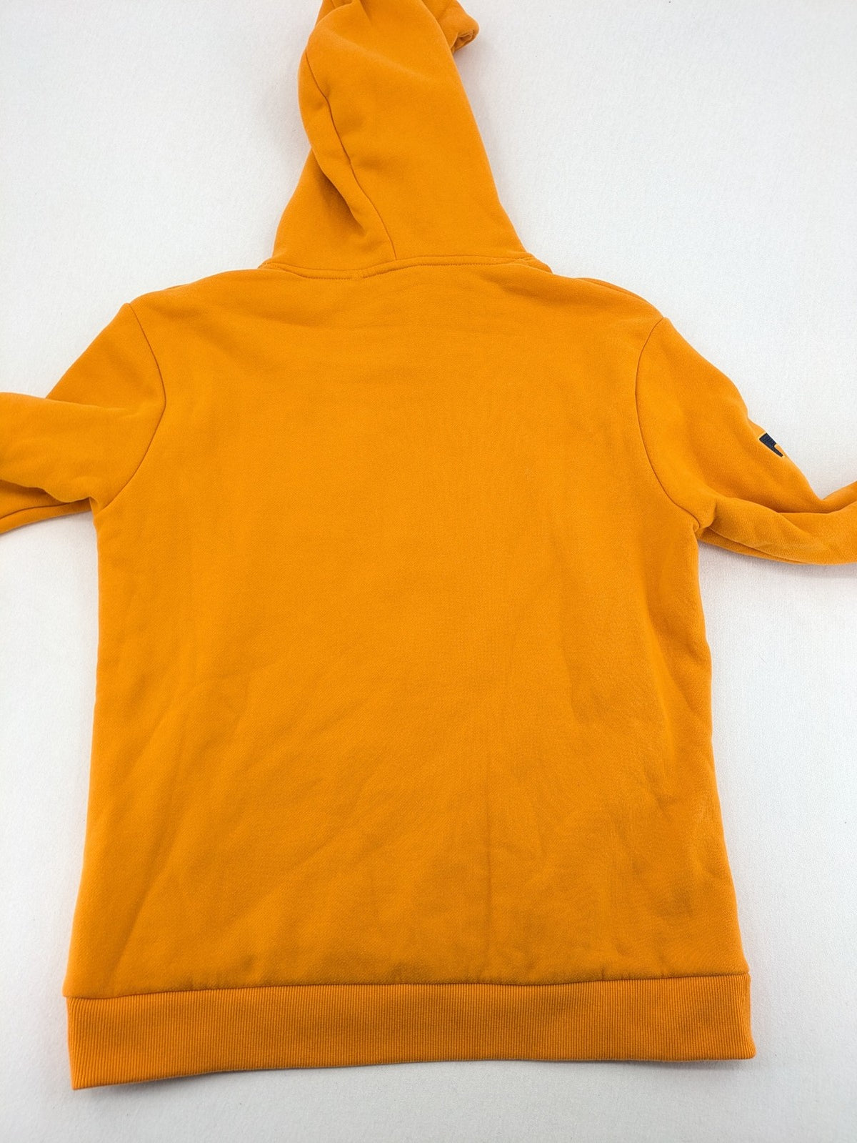 Superdry orange turtle neck jumper with textured logo patch and number 7 detail.