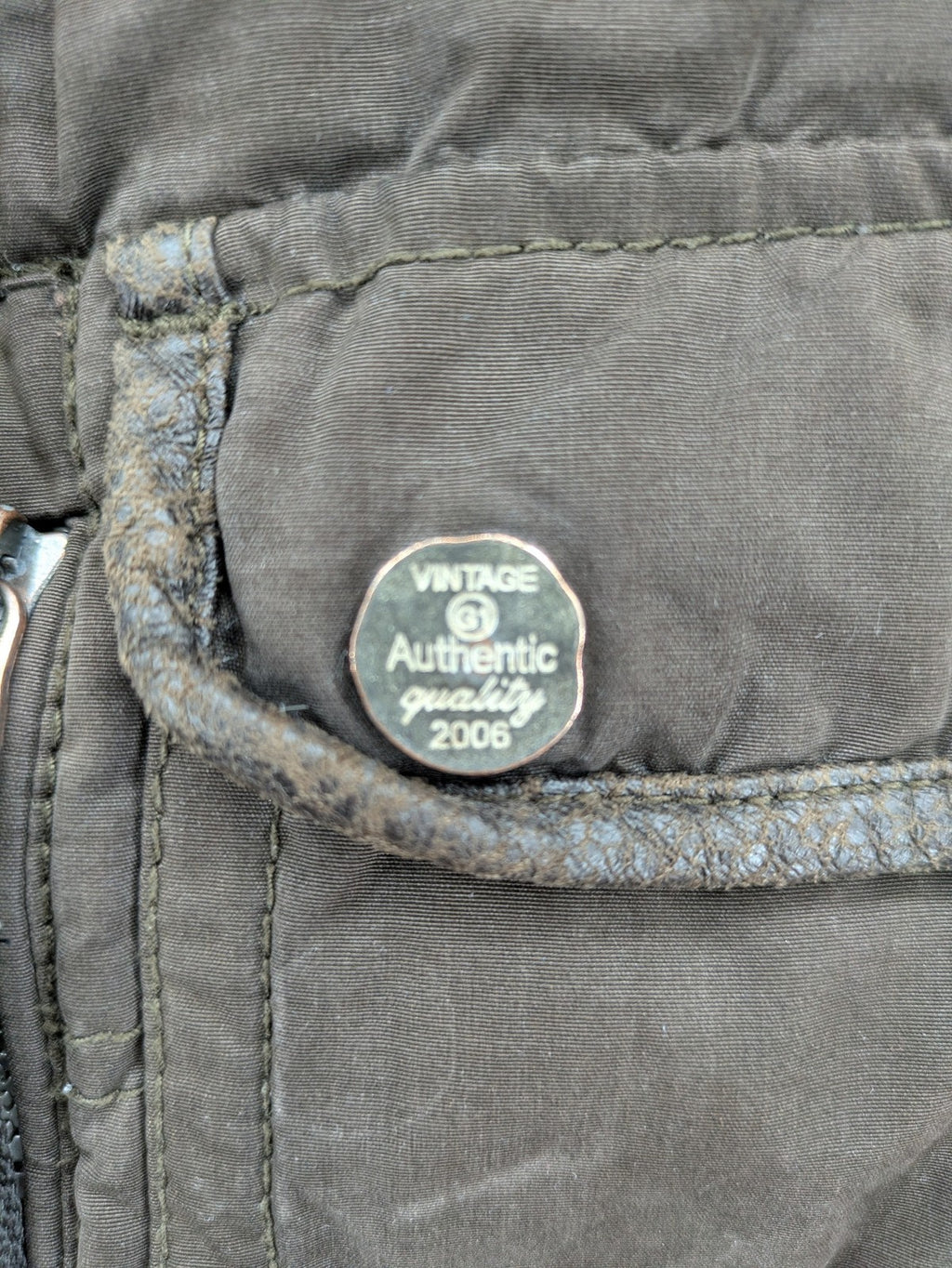 Gate One brown field jacket with plaid lining, multiple pockets, and zip-button closure.