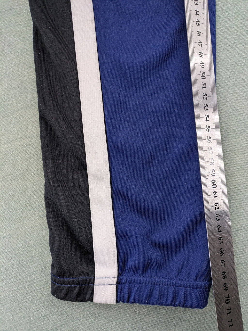 Nike Air blue jogging pants with black and white side stripes, elastic waistband.
