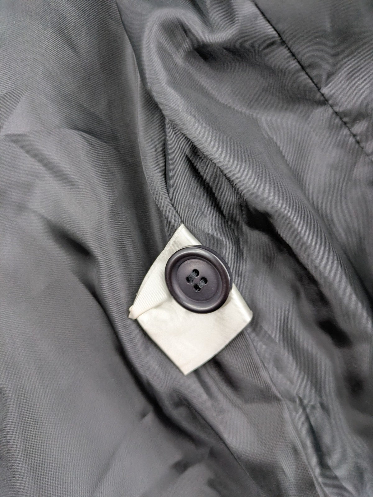 Lindex black blazer coat two-button design with subtle embroidery and tailored silhouette.