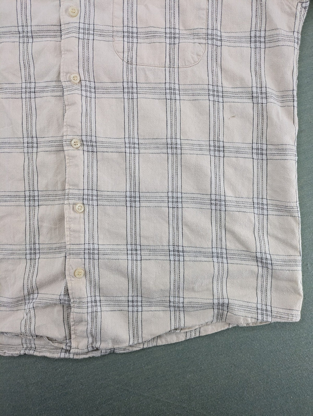 Ken Baker short-sleeve button-down shirt beige blue check pattern with single chest pocket.