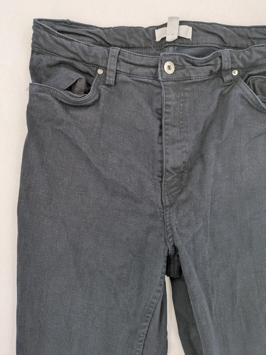 H&M grey skinny jeans with faded wash and soft stretch denim material.