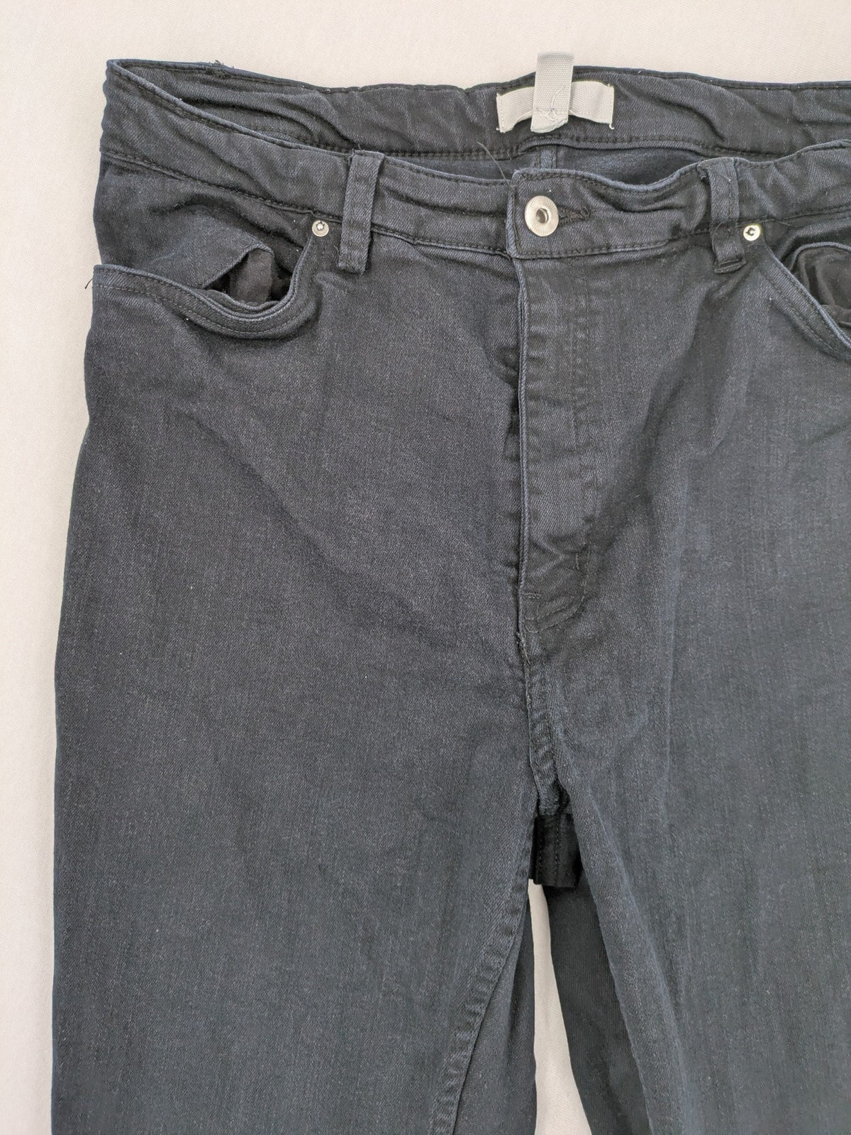 H&M grey skinny jeans with faded wash and soft stretch denim material.