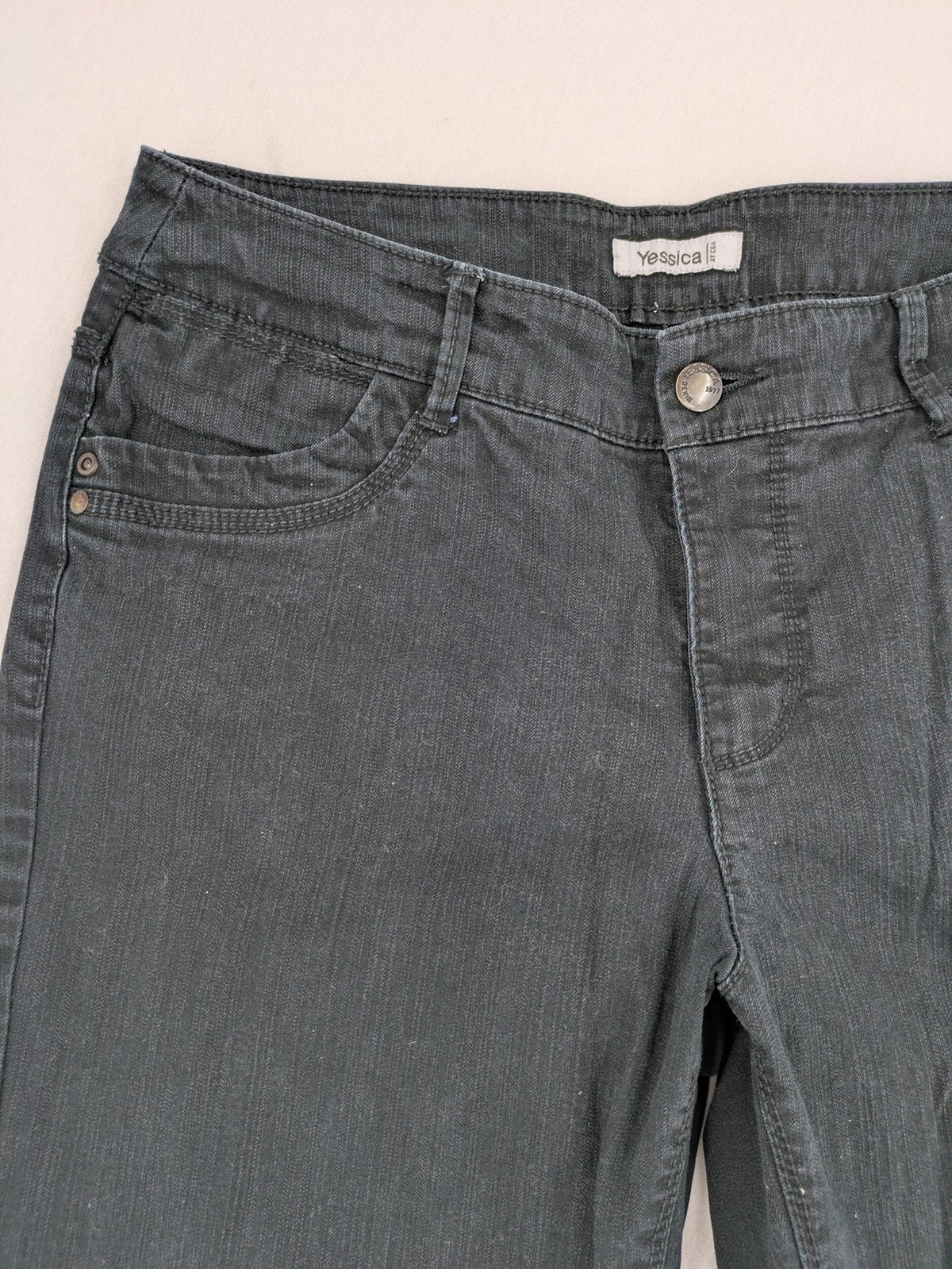 Yessica black straight jeans with classic dark wash and stretch denim material.