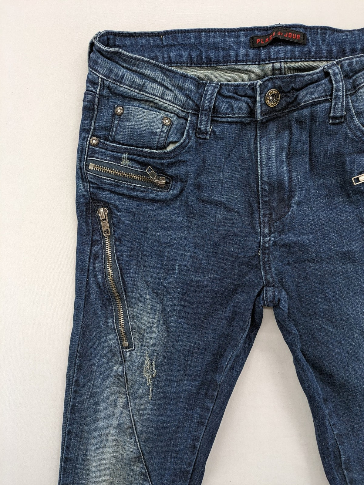 Place du Jour blue biker jeans with zippers, used-look wash, and star rivet detail.